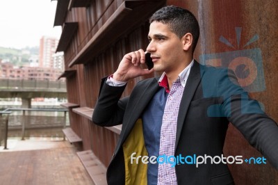 Portrait Of A Young Man With Talking On The Phone Stock Photo