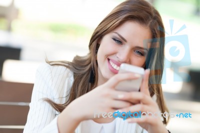 Portrait Of A Young Woman Using A Cellphone Stock Photo