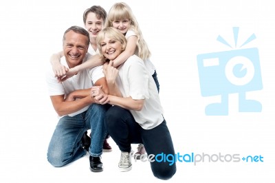 Portrait Of Affectionate Family Of Four In The Studio Stock Photo