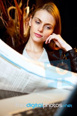 Portrait Of An Attractive Young Woman Who Reading Newspaper Stock Photo