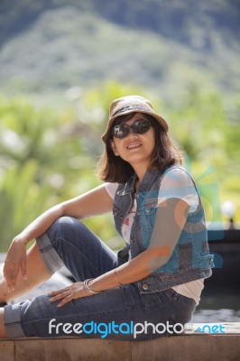 Portrait Of Asian 40s Years Woman Wearing Straw Hat And Sun Glasses Toothy Smiling Face With Happiness Emotion Relaxing On Vacation Stock Photo