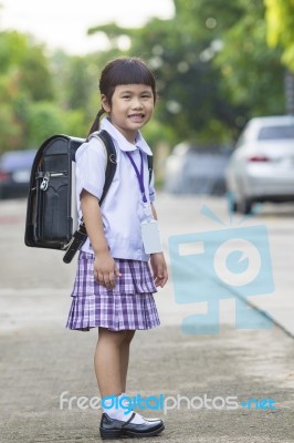 Portrait Of Asian Children Wearing Student Uniform Carrying School Backpack Toothy Smiling Face Stock Photo