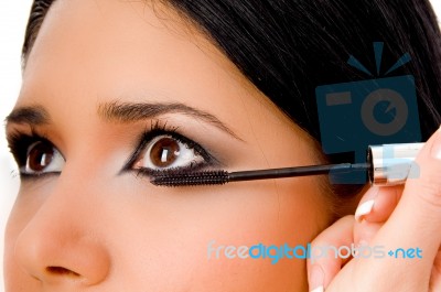 Portrait Of Beautician Applying Maskara On Woman's Eye Stock Photo