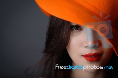 Portrait Of Beautiful Asian Woman Model In Orange Striped Hat Wi… Stock Photo