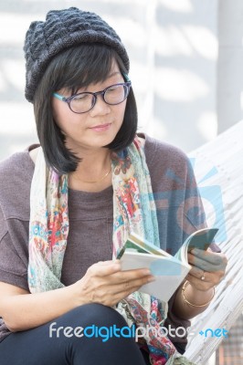 Portrait Of Beautiful Asian Woman Relaxing Time Reading Book On Cradle Happiness Emotion With Smiling Face Stock Photo