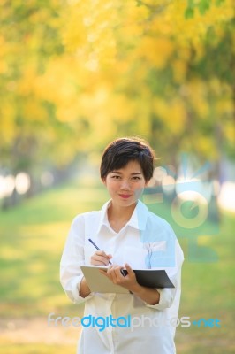 Portrait Of Beautiful Asian Young Woman Staning In Yellow Flower… Stock Photo