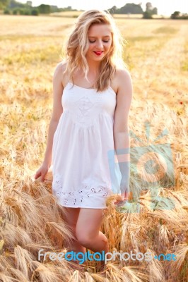 Portrait Of Beautiful Girl In Field Stock Photo