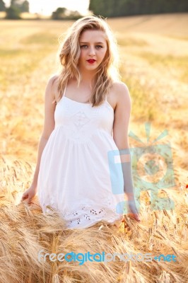 Portrait Of Beautiful Girl In Field Stock Photo