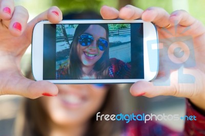 Portrait Of Beautiful Girl Taking A Selfie With Mobile Phone In Stock Photo