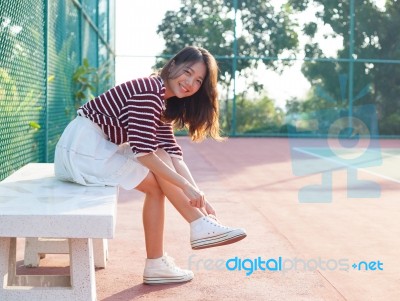 Portrait Of Beautiful Sport Girl Sitting In Tennis Courts  Looki… Stock Photo