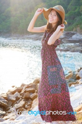 Portrait Of Beautiful Woman Wearing Straw Hat And Long Dress Sta… Stock Photo