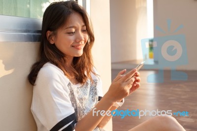 Portrait Of Beautiful Young And Teen Woman Looking To Mobile Pho… Stock Photo