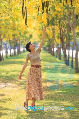 Portrait Of Beautiful Young Asian Woman Relaxing In Flowers Park… Stock Photo