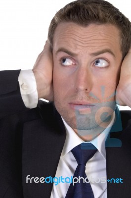 Portrait Of Businessman Stopping High Sound With His Hands Stock Photo