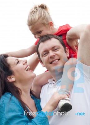 Portrait Of Cheerful Couple With Their Daughter Having Fun Stock Photo