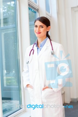 Portrait Of Confident Female Doctor In Lab Coat Stock Photo