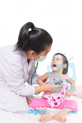 Portrait Of Confident Female Doctor Looking At Patient During Medical Treatment Stock Photo