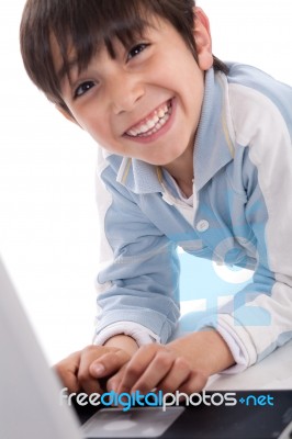 Portrait Of Cute Caucasian Boy Smiling With Laptop Stock Photo