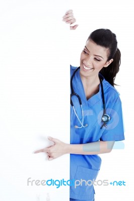 Portrait Of Female Nurse Standing Behind The White Board Stock Photo