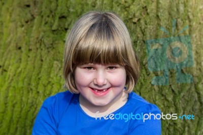 Portrait Of Girl In Front Of Oak Trunk With Bark Stock Photo