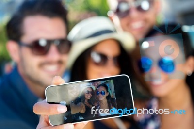 Portrait Of Group Friends Taking Photos With A Smartphone Stock Photo