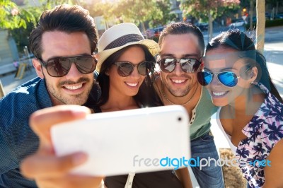 Portrait Of Group Friends Taking Photos With A Smartphone Stock Photo