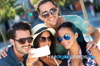 Portrait Of Group Friends Taking Photos With A Smartphone Stock Photo