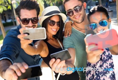 Portrait Of Group Friends Taking Photos With A Smartphone Stock Photo