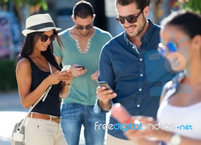 Portrait Of Group Of Friends Having Fun With Smartphones Stock Photo