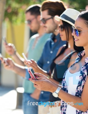 Portrait Of Group Of Friends Having Fun With Smartphones Stock Photo