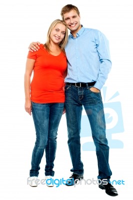 Portrait Of Happy Young Couple Hugging At Studio Stock Photo