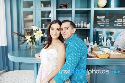 Portrait Of Happy Young Couple In Cafeteria Stock Photo