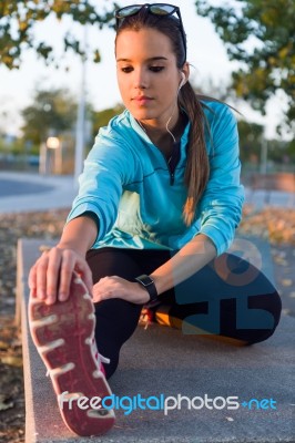 Portrait Of Running Woman Doing Stretching In The Park Stock Photo