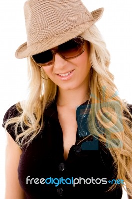 Portrait Of Smiling Female Wearing Hat And Sunglasses Stock Photo