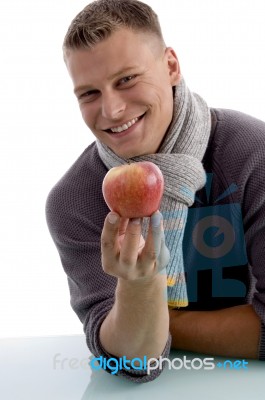 Portrait Of Smiling Man Holding Apple Stock Photo