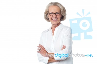 Portrait Of Smiling Old Lady, Arms Crossed Stock Photo