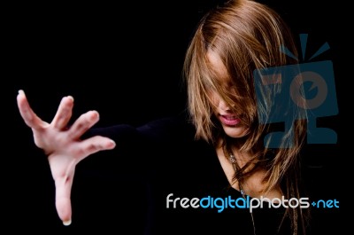 Portrait Of Smiling Woman Hiding Her Face With Hair Stock Photo