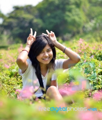 Portrait Of Sweet Young Woman Sitting Outdoors Stock Photo