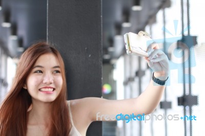 Portrait Of Thai Adult Beautiful Girl Using Her Smart Phone Selfie Stock Photo