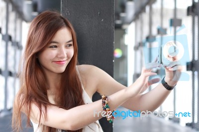 Portrait Of Thai Adult Beautiful Girl Using Her Smart Phone Selfie Stock Photo