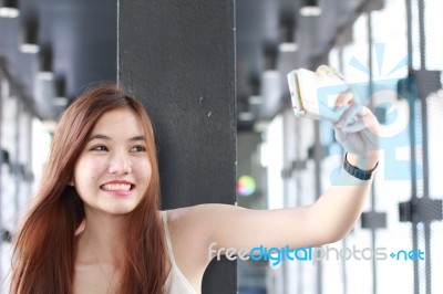 Portrait Of Thai Adult Beautiful Girl Using Her Smart Phone Selfie Stock Photo