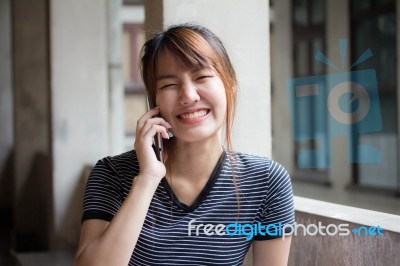 Portrait Of Thai Adult Beautiful Girl Using Her Smart Phone Selfie Stock Photo