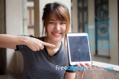 Portrait Of Thai Adult Beautiful Girl Using Her Tablet Stock Photo