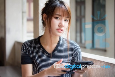 Portrait Of Thai Adult Beautiful Girl Using Her Tablet Stock Photo