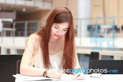 Portrait Of Thai Adult Beautiful Girl Write A Book And Smile In University Stock Photo