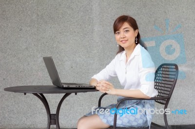 Portrait Of Thai Adult Businesswoman Beautiful Girl Using Computer Notebook Stock Photo