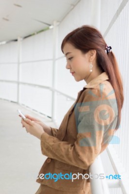 Portrait Of Thai Adult Businesswoman Beautiful Girl Using Her Smart Phone Stock Photo