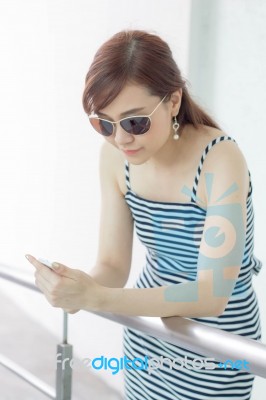 Portrait Of Thai Adult Businesswoman Beautiful Girl Using Her Smart Phone Stock Photo