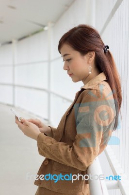 Portrait Of Thai Adult Businesswoman Beautiful Girl Using Her Smart Phone Stock Photo