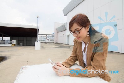 Portrait Of Thai Adult Businesswoman Beautiful Girl Using Her Smart Phone Stock Photo